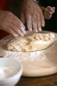 Dough Prints: Man kneading and rolling pastry with little girl helping - hands only shown credit