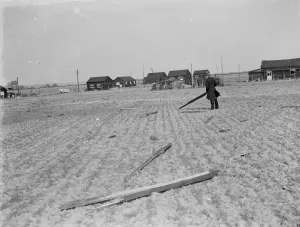 Debris Prints: A man picking up the debris following a factory explosion in Faversham, Kent