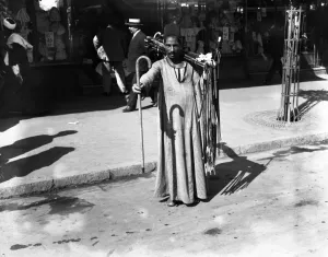 Fashionista Prints: A man selling walking sticks on the streets of Cairo, Egypt. 21 March 1923
