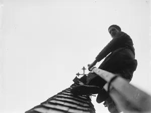 Man working up on the steeple of North Cray Church, Kent. 1936