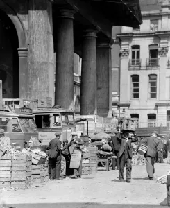 Baskets Prints: Market porters chatting amongst the fruit and vegetable boxes at Covent Gardens flower