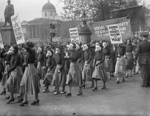 Masked women lead demonstrators in Trafalgar Square peace meeting. Led by women