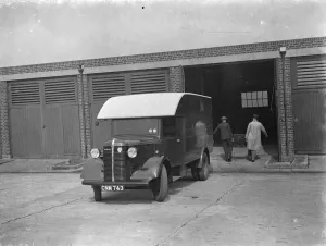 Unload Prints: Men carrying the totalisators from a Bedford truck at Hurst Park Racecourse in Molesey