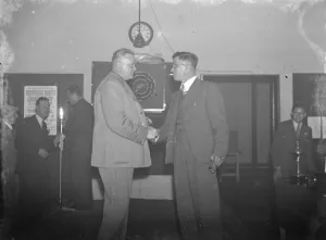 Two men shake hands at the Erith Hospital darts competition. 1939