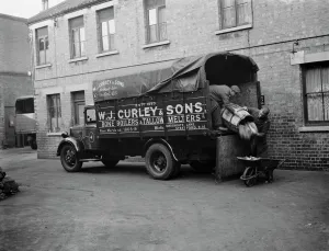Men unloading bones and animal waste from a WJ Curleys lorry at Stratford, East London