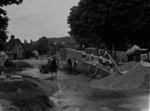 Men at work on river crossing at Eynsford bridge over the River Darent in Kent