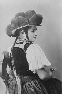 Millinery worn by woman on gala days in the Black Country of Germany. The poms poms