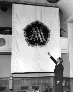 1960s Prints: A Ministry of Works Official examining one of the banners, which will be used in