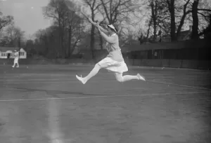 Miss Colyer in gallery tennis tournament. Miss E Colyer in action in the Open Singles