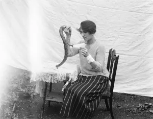 Eccentric Prints: Miss Delhi feeding her pet baby boa constrictor with bottles of milk. August 1922