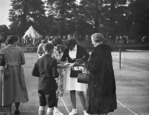 Personality Prints: Miss E M Denney at the Miller Hospital lawn tennis competition signing autographs. 1938