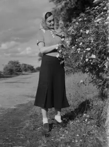 Miss Muriel Haken admiring some wild roses in Sussex. 13 June 1937