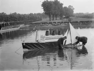 Model of the liner RMS Queen Mary is released upon the the water alongside a model yacht
