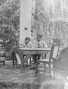 Head Of State Prints: The very modern Amir of Afghanistan. Amanulla Khan, seated beside his telephone