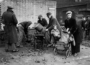 Family Collection: This mother with her baby loads her prams with coke after a long wait in the queue