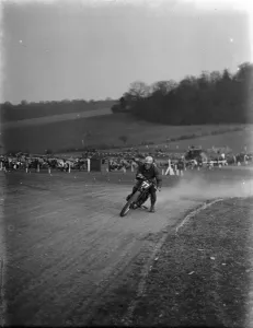Motor cycling races at Brands Hatch on Easter Sunday. W C Lock on a scramblers take