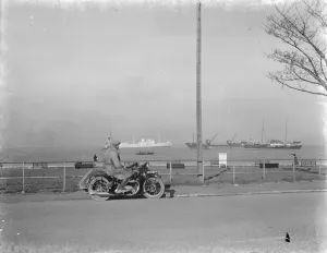 Ships Prints: A motorcyclist looks out at the traffic on the Thames estuary from Gravesend promenade