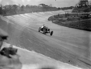 Mr C M Whites Bucatti. Taking the bridge on the railway straight in 2nd race
