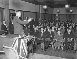 Meeting Prints: Mr D T Brand, the deputy high commissioner addressing young emigrants at Australia House