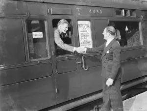 Platform Prints: Mr David Behar shakes the hand of a passengers on the train for the Dartford