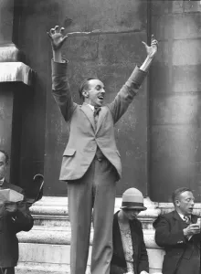 Suit Prints: Mr Gibson Young, organising Secretary of the Community Singers Association, conducts