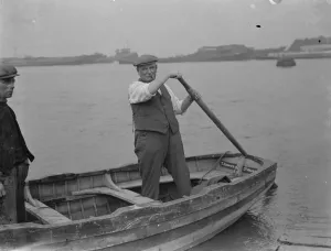 Mr J H Salmon, landlord of the Long Reach Tavern in Dartford, Kent, on a barge