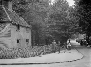Wooden Fence Prints: Mr JA Baxter of the Old Cottage, Lamorbey, Sidcup, Kent outside his cottage. 6