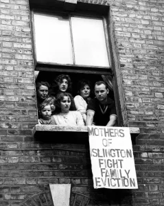 Living Conditions Prints: Mr McDonaugh and his wife with some of their children and friends looking from a