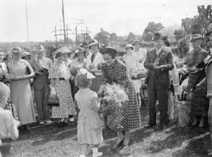 Presentation Prints: Mrs Bossom wife of Mr Alfred Bossom MP is presented with a bouquet after the official