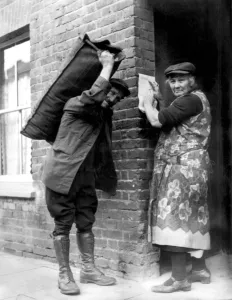 Coal Prints: Mrs Nicholson, 68 years old, of Arthur Road, Windsor, receiving Kings annual Christmas