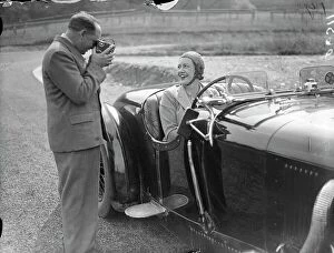 Press Collection: Mrs Roy ( Marjorie ) Eccles being filmed by her husband before racing on the track