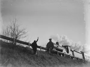 Smoke Prints: Muriel Haken waves to a passing train from a railway embankment. 1939