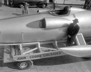 New Malden, Surrey: Driving ace John Cobb, with his revolutionary speed-boat Crusader