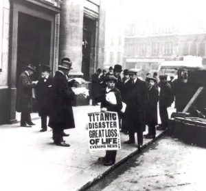 News Prints: A newspaper boy spreads the news of the sing of the Titanic to bystanders outside