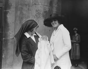 Baby Prints: A nurse holds the son of actor Lupino Lane at his christening at St Georges Church