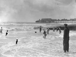 The official beach bathing attendant has a busy time keeping a watchful eye during rough weather