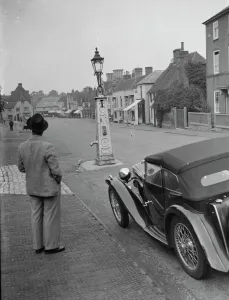 An old water pump used as a street lamp. West Malling. 14 September 1937