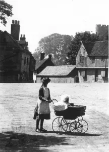 Apron Prints: An older sister taking out the baby in a perambulator on a summers day walk taking