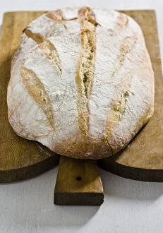 Organic Collection: Organic rustic white loaf on wooden cutting board credit: Marie-Louise Avery /