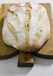 Wood Prints: Organic rustic white loaf on wooden cutting board credit: Marie-Louise Avery /