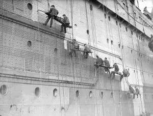 Ships Prints: Painters are at work on the huge task of painting the hull of the Cunard White Star