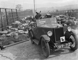 An pair of alsations sit in the a learners car. 1936
