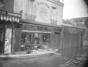 Paris and its suburbs under water. A baker removing his goods from his shop which