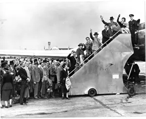 Passengers for the worlds first jet airliner service are shepherded aboard the BOAC