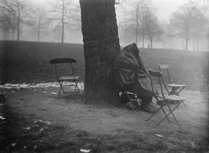 A pathetic scene in Londons cold. A human derelict. a women huddled beneath