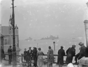 People gather on the river side to watch the Home Fleet on the Thames at Erith, London