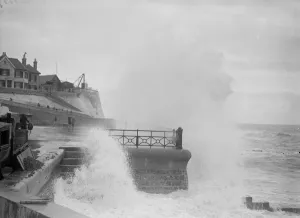 People running for shelter from great waves which broke over the seafront at Rottingdean