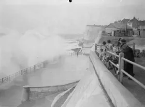 People running for shelter from great waves which broke over the seafront at Rottingdean
