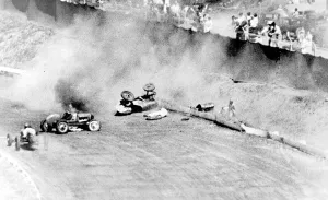 Phil Lacatiers driver car blazing on the track with Lacatier lies prone beside
