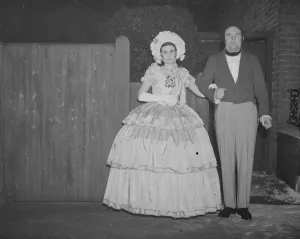 Photographer, Mr John Topham with Miss Haken, dressed in Victorian costume. 1938